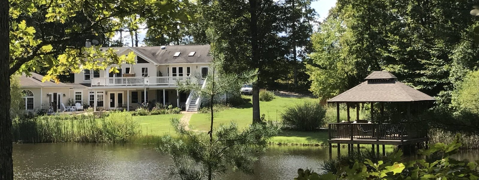 The lake and wooded landscape at Bridge Between the Worlds